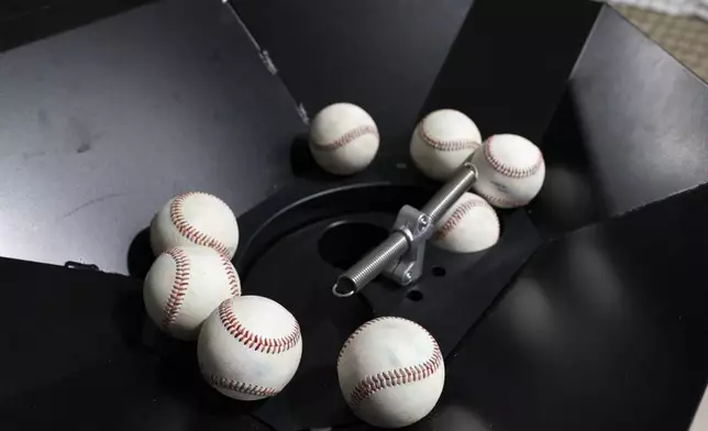 Baseballs wait to be sent through The Trajekt Arc pitching machine as the device is demonstrated during the Major League Baseball winter meetings Wednesday, Dec. 6, 2023, in Nashville, Tenn. (AP Photo/George Walker IV)