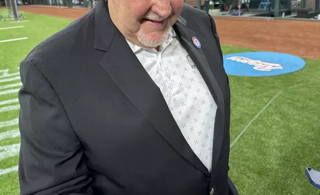 Texas Rangers longtime public address announcer Chuck Morgan admires his World Series championship ring, Saturday, March 30, 2024 in Arlington Texas. The Texas Rangers and staff will receive their World Series championship rings during a pre-game ceremony before the Texas Rangers take on the Chicago Cubs in a baseball game. (AP Photo/Stephen Hawkins)