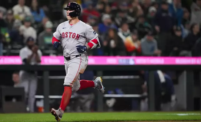 Boston Red Sox's Tyler O'Neill nears home after hitting a home run against the Seattle Mariners during the eighth inning of an opening-day baseball game Thursday, March 28, 2024, in Seattle. (AP Photo/Lindsey Wasson)