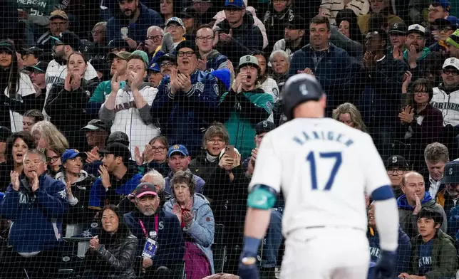 Seattle Mariners' Mitch Haniger gets a standing ovation from fans as he approaches the plate to bat against the Boston Red Sox during the second inning of an opening-day baseball game Thursday, March 28, 2024, in Seattle. (AP Photo/Lindsey Wasson)