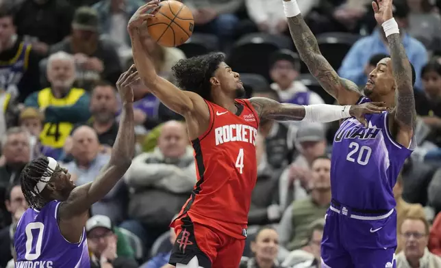 Houston Rockets guard Jalen Green (4) goes to the basket as Utah Jazz's Taylor Hendricks (0) and John Collins (20) defend during the first half of an NBA basketball game Friday, March 29, 2024, in Salt Lake City. (AP Photo/Rick Bowmer)