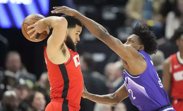 Utah Jazz guard Collin Sexton, right, defends against Houston Rockets guard Fred VanVleet during the first half of an NBA basketball game Friday, March 29, 2024, in Salt Lake City. (AP Photo/Rick Bowmer)