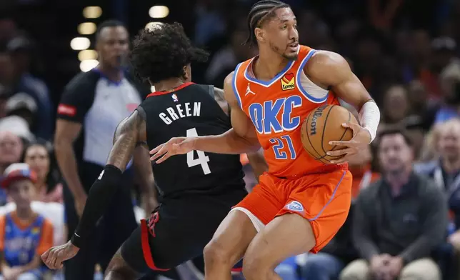Oklahoma City Thunder guard Aaron Wiggins (21) spins away from Houston Rockets guard Jalen Green (4) during the second half of an NBA basketball game Wednesday, March 27, 2024, in Oklahoma City. (AP Photo/Nate Billings)