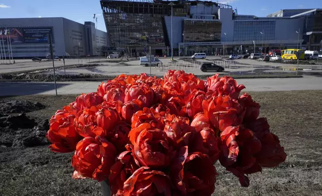 Flowers lie in front of the Crocus City Hall on the western outskirts of Moscow, Russia, Wednesday, March 27, 2024. Russian officials persisted Tuesday in saying Ukraine and the West had a role in last week's deadly Moscow concert hall attack despite vehement denials of involvement by Kyiv and a claim of responsibility by an affiliate of the Islamic State group. (AP Photo/Alexander Zemlianichenko)
