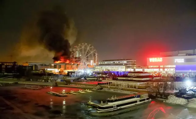 FILE - A massive blaze is seen over the Crocus City Hall concert venue on the western edge of Moscow, Russia, Friday, March 22, 2024. The attack on the venue that killed over 140 people marked a major failure of Russian security agencies. (Sergei Vedyashkin/Moscow News Agency via AP, File)