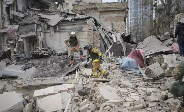 First response officers inspect the damage after a Russian air attack in Kyiv, Ukraine, Monday March 25, 2024. Five people were injured in the strike at Pechersk district of Kyiv, two were hospitalised.(AP Photo/Vadim Ghirda)