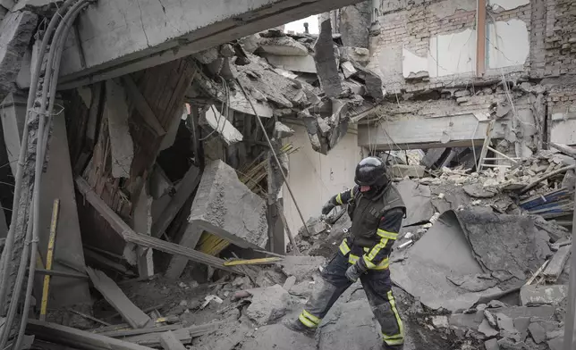 A first responder officer inspects the damage in a building at the Pechersk district, after a Russian air attack in Kyiv, Ukraine, Monday March 25, 2024. Five people were injured in the strike, two were hospitalised.(AP Photo/Vadim Ghirda)