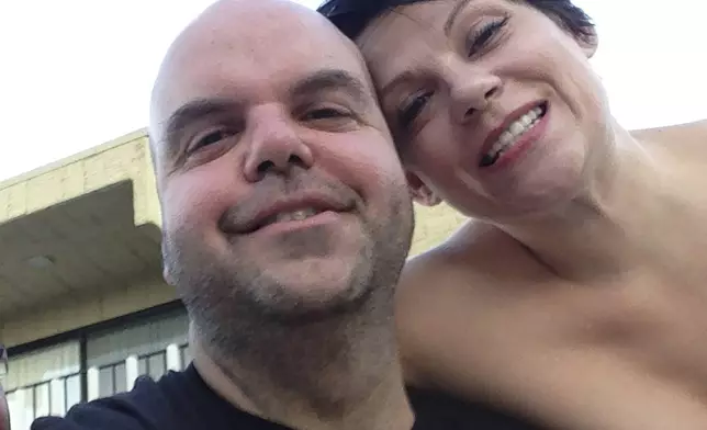 In a selfie taken in July 2014, Johnathan Walton poses with Marianne Smyth during a vacation in Palm Springs, Calif. Smyth is in a Maine jail awaiting a hearing in April 2024 that will decide whether she can be extradited to the United Kingdom over a scam dating back more than 15 years in Northern Ireland. She is accused of stealing more than $170,000 from at least five victims from 2008 to 2010 in Northern Ireland, according to court records. (Johnathan Walton via AP)