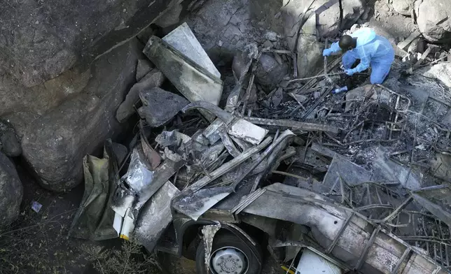 The wreckage off a bus lays in a ravine a day after it plunged off a bridge on the Mmamatlakala mountain pass between Mokopane and Marken, around 300km (190 miles) north of Johannesburg, South Africa, Friday, March 29, 2024. A bus carrying worshippers on a long-distance trip from Botswana to an Easter weekend church gathering in South Africa plunged off a bridge on a mountain pass Thursday and burst into flames as it hit the rocky ground below, killing at least 45 people, authorities said. The only survivor was an 8-year-old child who was receiving medical attention for serious injuries. (AP Photo/Themba Hadebe)