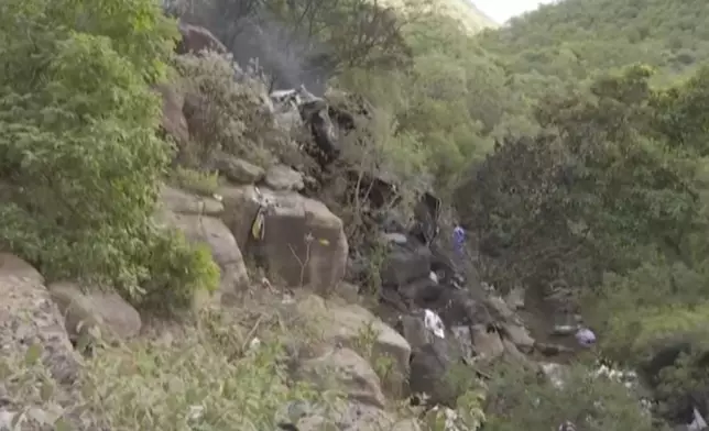 In this image taken from video provided by eNCA, a bus carrying worshippers headed to an Easter festival plunged off a bridge on a mountain pass and burst into flames in Limpopo, South Africa, on Thursday, March 28, 2024, killing multiple people, authorities said. (eNCA via AP)