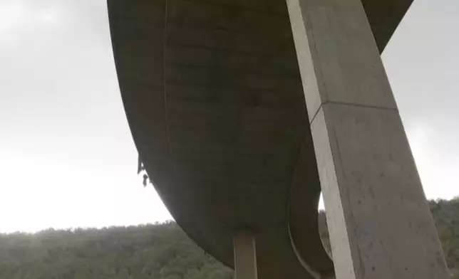 In this image taken from video provided by eNCA, a bus carrying worshippers headed to an Easter festival plunged off a bridge on a mountain pass and burst into flames in Limpopo, South Africa, on Thursday, March 28, 2024, killing multiple people, authorities said. (eNCA via AP)