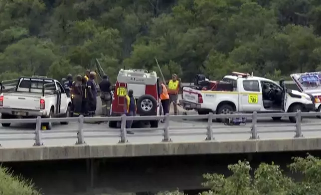 In this image taken from video provided by eNCA, a bus carrying worshippers headed to an Easter festival plunged off a bridge on a mountain pass and burst into flames in Limpopo, South Africa, on Thursday, March 28, 2024, killing multiple people, authorities said. (eNCA via AP)