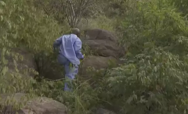 In this image taken from video provided by eNCA, a bus carrying worshippers headed to an Easter festival plunged off a bridge on a mountain pass and burst into flames in Limpopo, South Africa, on Thursday, March 28, 2024, killing multiple people, authorities said. (eNCA via AP)