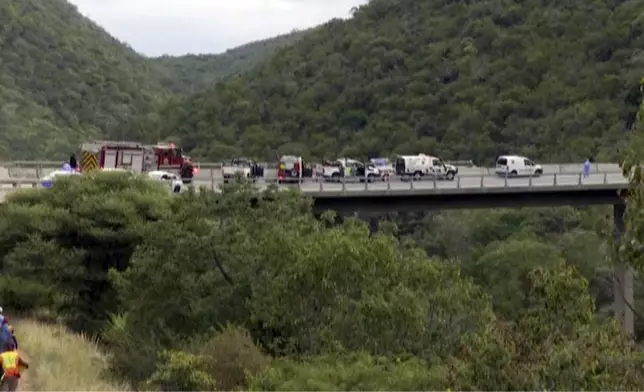 In this image taken from video provided by eNCA, a bus carrying worshippers headed to an Easter festival plunged off a bridge on a mountain pass and burst into flames in Limpopo, South Africa, on Thursday, March 28, 2024, killing multiple people, authorities said. (eNCA via AP)