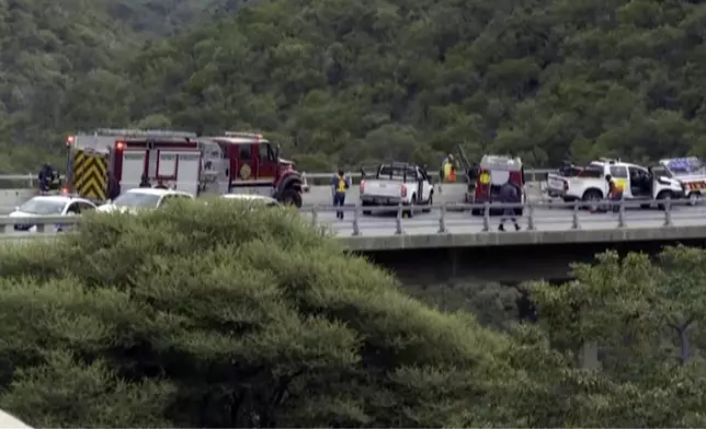 In this image taken from video provided by eNCA, a bus carrying worshippers headed to an Easter festival plunged off a bridge on a mountain pass and burst into flames in Limpopo, South Africa, on Thursday, March 28, 2024, killing multiple people, authorities said. (eNCA via AP)