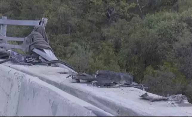 In this image taken from video provided by eNCA, a bus carrying worshippers headed to an Easter festival plunged off a bridge on a mountain pass and burst into flames in Limpopo, South Africa, on Thursday, March 28, 2024, killing multiple people, authorities said. (eNCA via AP)