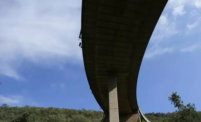 A view of a bridge over a ravine where a bus plunged onto a mountain pass on Thursday, in the Limpopo Province, South Africa., Friday, March 29, 2024. Authorities say a bus carrying worshippers headed to an Easter weekend church gathering plunged off a bridge on a mountain pass and burst into flames in South Africa, killing at least 45 people. The only survivor of Thursday's crash was an 8-year-old child, who was receiving medical attention. (AP Photo/Themba Hadebe)