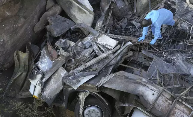 The wreckage off a bus lays in a ravine a day after it plunged off a bridge on the Mmamatlakala mountain pass between Mokopane and Marken, around 300km (190 miles) north of Johannesburg, South Africa, Friday, March 29, 2024. A bus carrying worshippers on a long-distance trip from Botswana to an Easter weekend church gathering in South Africa plunged off a bridge on a mountain pass Thursday and burst into flames as it hit the rocky ground below, killing at least 45 people, authorities said. The only survivor was an 8-year-old child who was receiving medical attention for serious injuries. (AP Photo/Themba Hadebe)