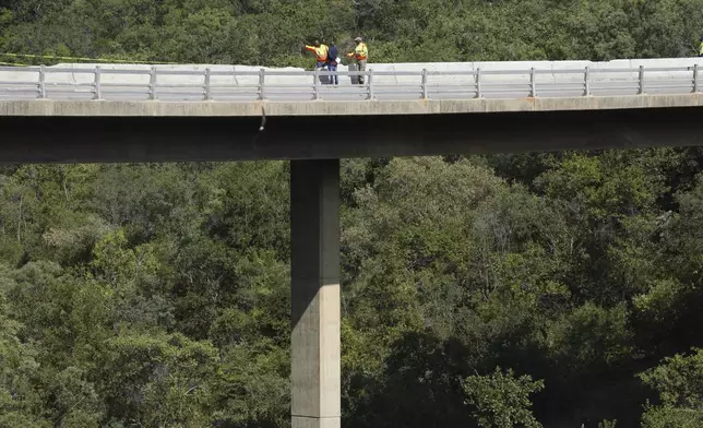 A view of a bridge a day after a bus plunged into a ravine on the Mmamatlakala mountain pass between Mokopane and Marken, around 300km (190 miles) north of Johannesburg, South Africa, Friday, March 29, 2024. A bus carrying worshippers on a long-distance trip from Botswana to an Easter weekend church gathering in South Africa plunged off a bridge on a mountain pass Thursday and burst into flames as it hit the rocky ground below, killing at least 45 people, authorities said. The only survivor was an 8-year-old child who was receiving medical attention for serious injuries. (AP Photo/Themba Hadebe)