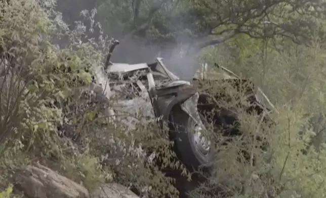 In this image taken from video provided by eNCA, a bus carrying worshippers headed to an Easter festival plunged off a bridge on a mountain pass and burst into flames in Limpopo, South Africa, on Thursday, March 28, 2024, killing multiple people, authorities said. (eNCA via AP)