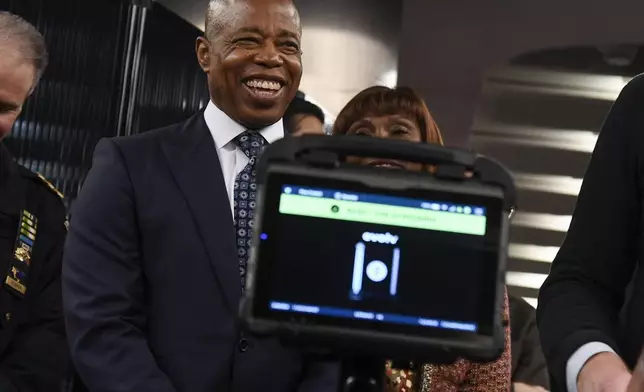 In this photo provided by The Metropolitan Transportation Authority (MTA), Mayor Eric Adams smiles during a news conference about new portable weapon detectors in New York, March 28, 2024. New York City officials announced a pilot program on Thursday to deploy portable gun scanners in the subway system, part of an effort to deter violence underground and to make the system feel safer. (Marc A. Hermann/Metropolitan Transportation Authority via AP)