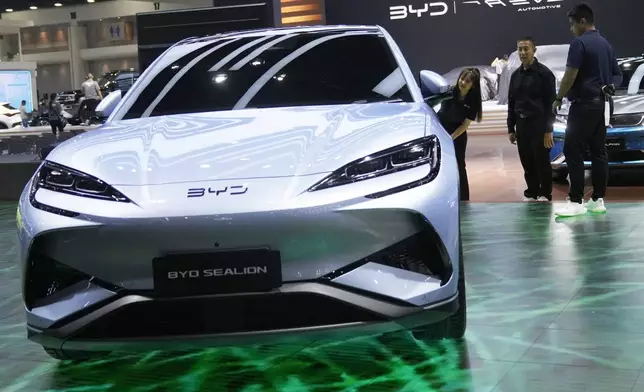 Visitors look at BYD's electric vehicle "Sealion" during the 45th Bangkok Motor Show in Nonthaburi , Tuesday, March 26, 2024. Thailand. (AP Photo/Sakchai Lalit)