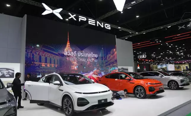 Visitors look at XPENG's electric vehicles during the 45th Bangkok Motor Show in Nonthaburi, Thailand, Tuesday, March 26, 2024. (AP Photo/Sakchai Lalit)