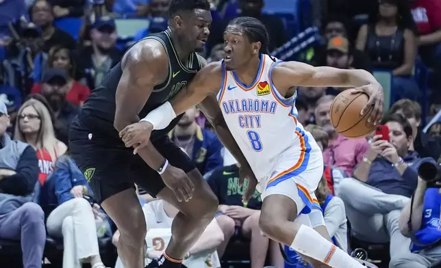 Oklahoma City Thunder forward Jalen Williams (8) drives to the basket against New Orleans Pelicans forward Zion Williamson in the first half of an NBA basketball game in New Orleans, Tuesday, March 26, 2024. (AP Photo/Gerald Herbert)