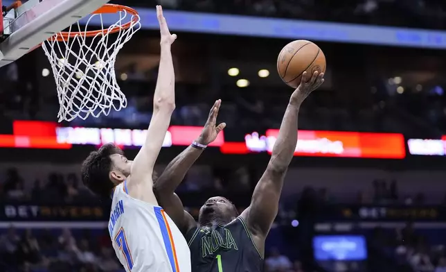 New Orleans Pelicans forward Zion Williamson (1) shoots against Oklahoma City Thunder forward Chet Holmgren (7) in the first half of an NBA basketball game in New Orleans, Tuesday, March 26, 2024. (AP Photo/Gerald Herbert)