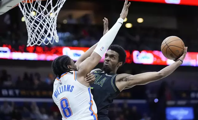 New Orleans Pelicans forward Herbert Jones (5) goes to the basket against Oklahoma City Thunder forward Jalen Williams (8) in the first half of an NBA basketball game in New Orleans, Tuesday, March 26, 2024. (AP Photo/Gerald Herbert)