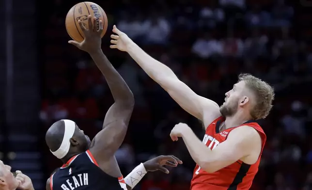Portland Trail Blazers center Duop Reath, left, and Houston Rockets center Jock Landale battle for the opening tip off during the first half of an NBA basketball game Monday, March 25, 2024, in Houston. (AP Photo/Michael Wyke)
