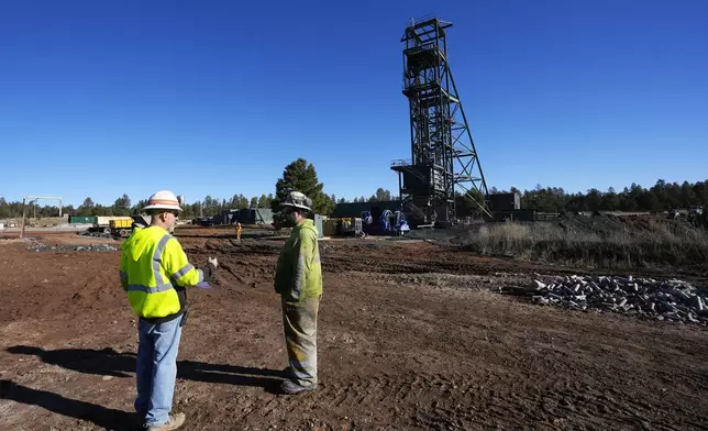 Workers talk at the Energy Fuels Inc. uranium Pinyon Plain Mine Wednesday, Jan. 31, 2024, near Tusayan, Ariz. The largest uranium producer in the United States is ramping up work just south of Grand Canyon National Park on a long-contested project that largely has sat dormant since the 1980s. (AP Photo/Ross D. Franklin)