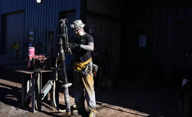 A woker checks on a piece of mining equipment at the Energy Fuels Inc. uranium Pinyon Plain Mine Wednesday, Jan. 31, 2024, near Tusayan, Ariz. The largest uranium producer in the United States is ramping up work just south of Grand Canyon National Park on a long-contested project that largely has sat dormant since the 1980s. (AP Photo/Ross D. Franklin)