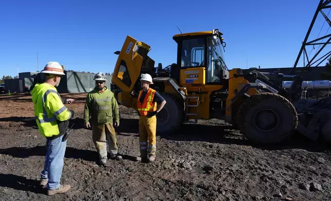 Workers talk at the Energy Fuels Inc. uranium Pinyon Plain Mine Wednesday, Jan. 31, 2024, near Tusayan, Ariz. The largest uranium producer in the United States is ramping up work just south of Grand Canyon National Park on a long-contested project that largely has sat dormant since the 1980s. (AP Photo/Ross D. Franklin)