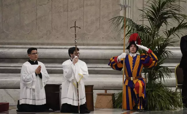 A Swiss guard gestures as Pope Francis celebrates the Holy Chrism Mass in St. Peter's Basilica, at The Vatican, Thursday, March 28, 2024. (AP Photo/Gregorio Borgia)