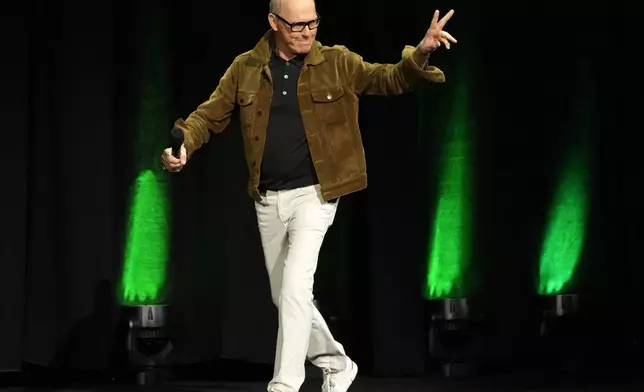 Michael Keaton, a cast member in the upcoming film "Beetlejuice Beetlejuice," waves to the audience as he arrives onstage for the Warner Bros. Pictures presentation at CinemaCon 2024, Tuesday, April 9, 2024, in Las Vegas. (AP Photo/Chris Pizzello)