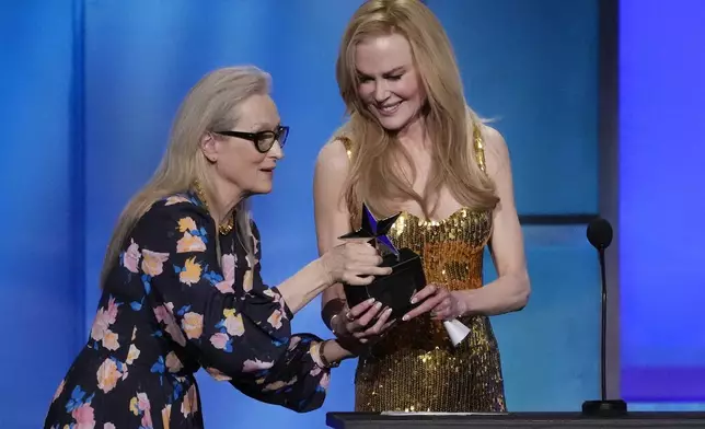 Meryl Streep, left, presents the 49th AFI Life Achievement Award to Nicole Kidman, Saturday, April 27, 2024, at the Dolby Theatre in Los Angeles. (AP Photo/Chris Pizzello)