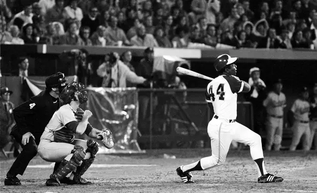 FILE - Atlanta Braves' Hank Aaron (44) breaks Babe Ruth's record for career home runs as he hits No. 715 off Los Angeles Dodgers pitcher Al Downing in the fourth inning of a baseball game at Atlanta-Fulton County Stadium in Atlanta, Ga., April 8, 1974. Just in time for the 50-year anniversary of Hank Aaron's record 715th home run, Charlie Russo is making available video he shot of the homer. (AP Photo)