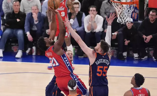 Philadelphia 76ers' Joel Embiid (21) shoots over New York Knicks' Isaiah Hartenstein (55) during the second half of Game 2 in an NBA basketball first-round playoff series Monday, April 22, 2024, in New York. (AP Photo/Frank Franklin II)