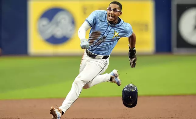 Tampa Bay Rays' Richie Palacios races home to score on an RBI triple by Amed Rosario off Los Angeles Angels starting pitcher Griffin Canning during the first inning of a baseball game Thursday, April 18, 2024, in St. Petersburg, Fla. (AP Photo/Chris O'Meara)