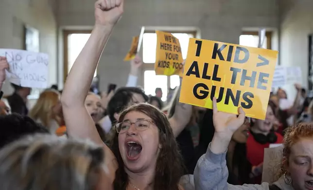 Emmie Wolf-Dubin, center, yells during a protest outside the House chamber after legislation passed that would allow some teachers to be armed in schools during a legislative session Tuesday, April 23, 2024, in Nashville, Tenn. (AP Photo/George Walker IV)