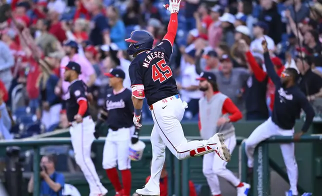Washington Nationals' Joey Meneses runs to first base celebrating his 10th inning hit to drive in the game-winning run to defeat the Houston Astros 5-4 in a inning baseball game at Nationals Park, Saturday, April 20, 2024, in Washington. (AP Photo/John McDonnell)
