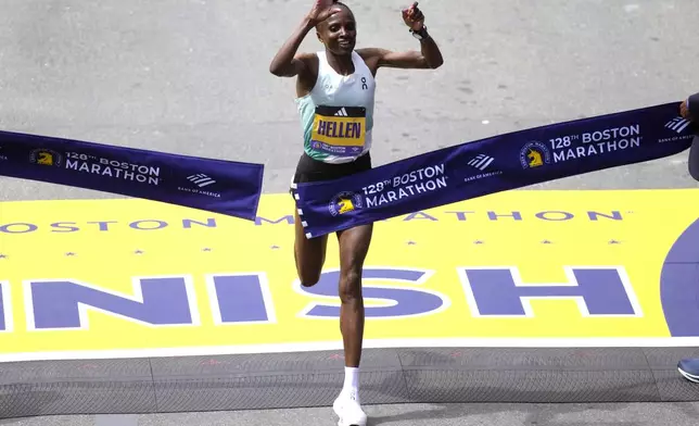 Hellen Obiri, of Kenya, raises her arms as she wins the women's division at the Boston Marathon, Monday, April 15, 2024, in Boston. (AP Photo/Charles Krupa)