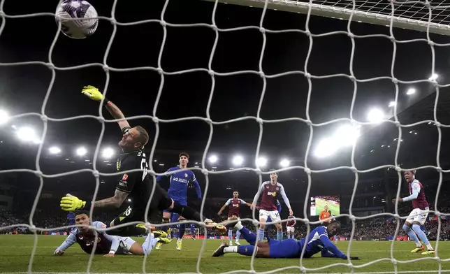 Chelsea's Axel Disasi, center, scores their side's third goal of the game before ruled out for a foul via VAR during the English Premier League soccer match between Aston Villa and FC Chelsea in Birmingham, England, Saturday, April 27, 2024. (Nick Potts/PA via AP)