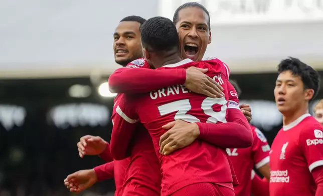 Liverpool's Ryan Gravenberch, front, celebrates with Liverpool's Virgil van Dijk after scoring his side's second goal during the English Premier League soccer match between Fulham and Liverpool at Craven Cottage stadium in London, Sunday, April 21, 2024. (AP Photo/Kirsty Wigglesworth)