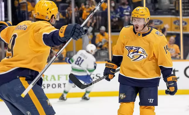 Nashville Predators center Gustav Nyquist (14) celebrates his goal against the Vancouver Canucks with teammate left wing Filip Forsberg (9) during the second period in Game 4 of an NHL hockey Stanley Cup first-round playoff series Sunday, April 28, 2024, in Nashville, Tenn. (AP Photo/George Walker IV)