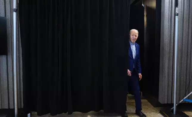 President Joe Biden steps out from behind a curtain before greeting steelworkers at United Steelworkers Headquarters, Wednesday, April 17, 2024, in Pittsburgh, Pa. (AP Photo/Alex Brandon)