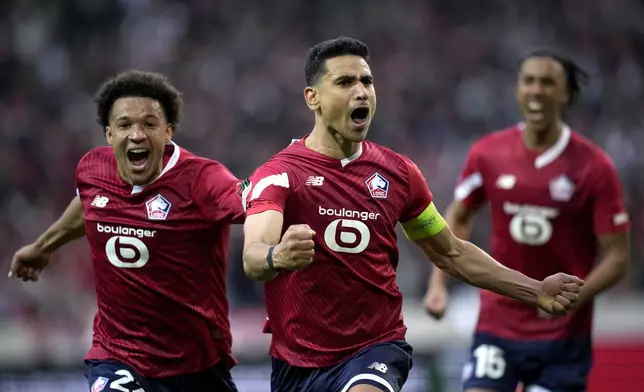 Lille's Benjamin Andre, center, celebrates with his teammates Tiago Santos, left, and Leny Yoro, right, after scoring the second goal against Aston Villa during the Europa Conference League quarter final second leg soccer match between Lille and Aston Villa at the Pierre Mauroy stadium in Villeneuve d'Ascq, northern France, Thursday, April 18, 2024. (AP Photo/Christophe Ena)