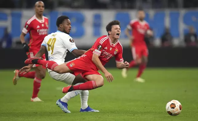 Marseille's Raimane Daou in action against Benfica's Joao Neves during the Europa League quarter final second leg soccer match between Olympique de Marseille and SL Benfica at the Velodrome stadium in Marseille, south of France, Thursday, April 18, 2024. (AP Photo/Daniel Cole)