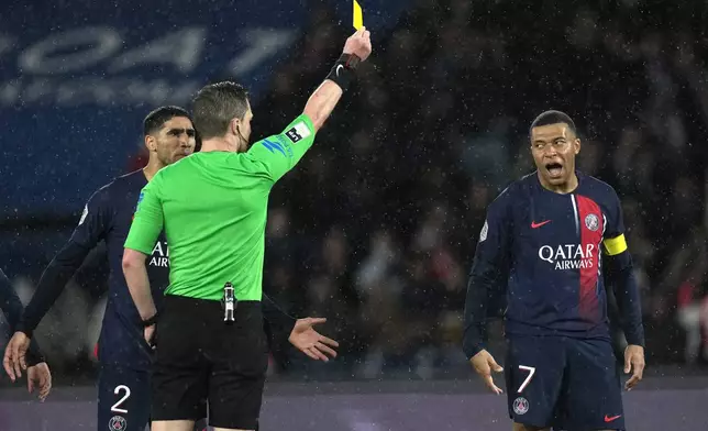 PSG's Kylian Mbappe reacts after getting a yellow card during the French League One soccer match between Paris Saint-Germain and Le Havre at the Parc des Princes in Paris, Saturday, April 27, 2024. (AP Photo/Thibault Camus)